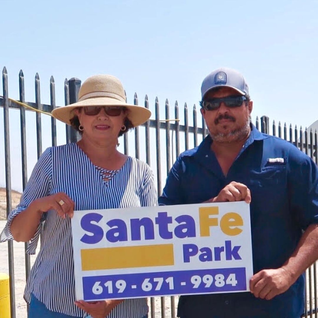 Business owners holding sign