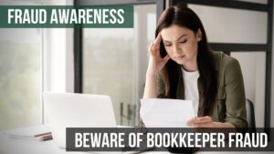 Business Owner looking over paperwork at a laptop